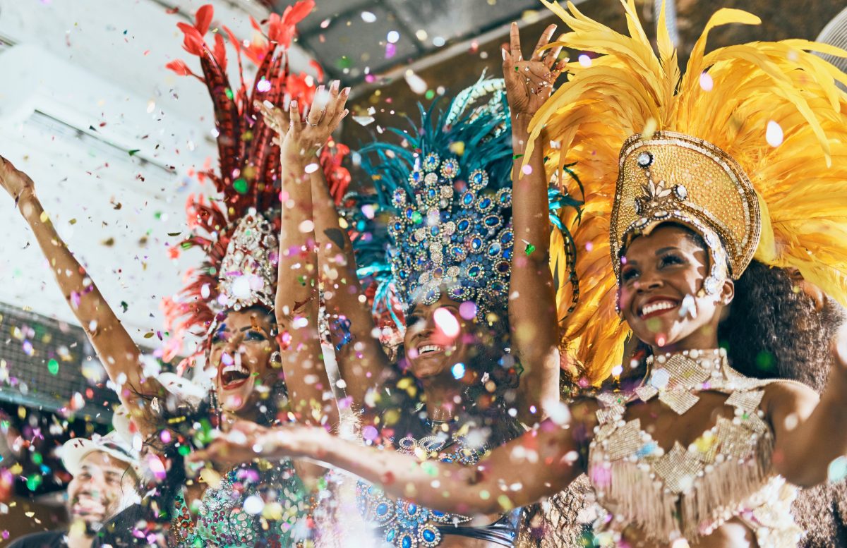 women dressed in sparkly costumes during a carnival celebration.