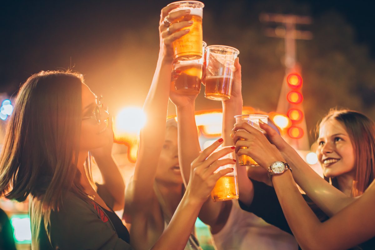 Group of female friends enjoying beer at a park, one of the best things to do in Flagstaff in fall.