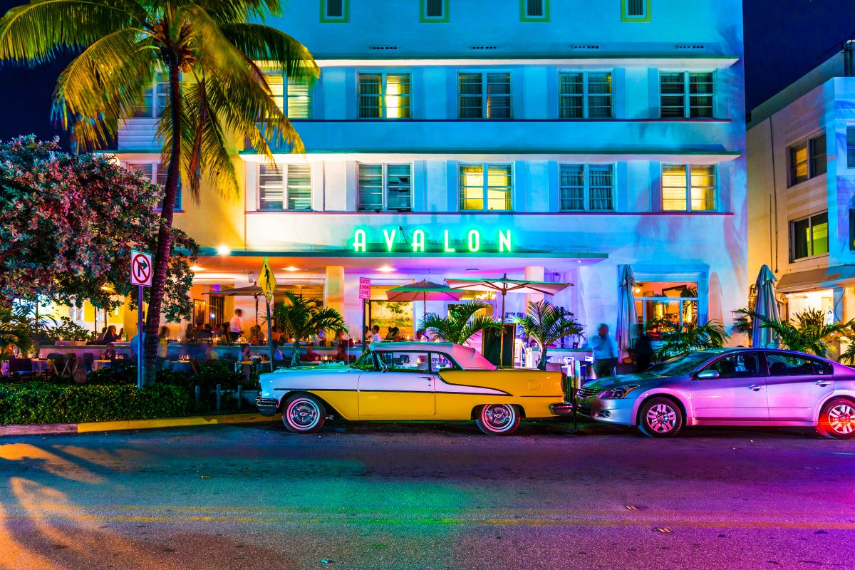 cars parked in front of one of the clubs and bars along south beach. is one of the main tourist attractions in miami.