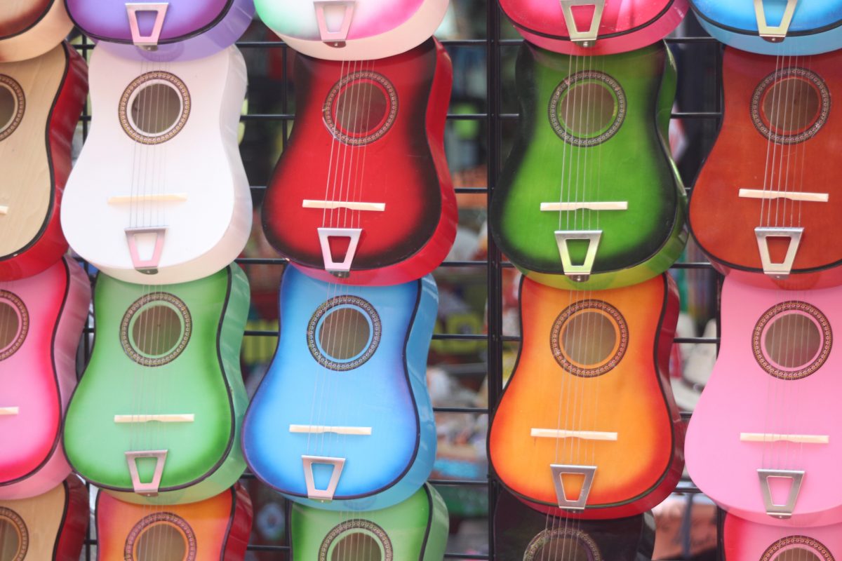 ukuleles in different colors for sale in a store, one of the top hawaii souvenirs. 
