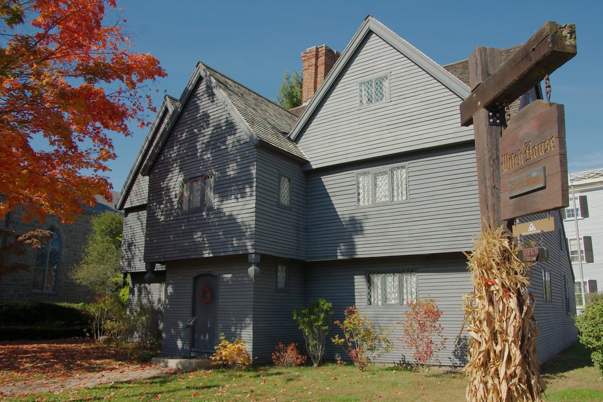 exterior of the witch house in salem during october with fall foliage.