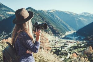 A female travel photographer holding a camera