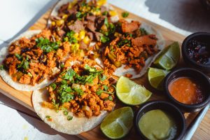 close-up of the best tacos in san diego on a wooden board.