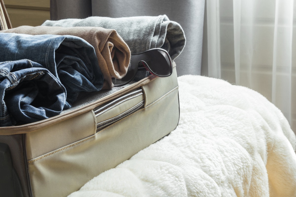 10 Survival Tips If You Face A Blackout While Traveling open suitcase with clothes on the bed - 10 Survival Tips If You Face A Blackout While Traveling