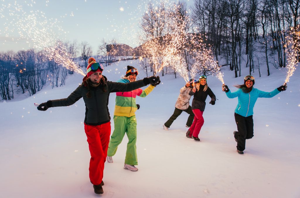 Friends playing on the Aspen mountains, celebrating and having fun.