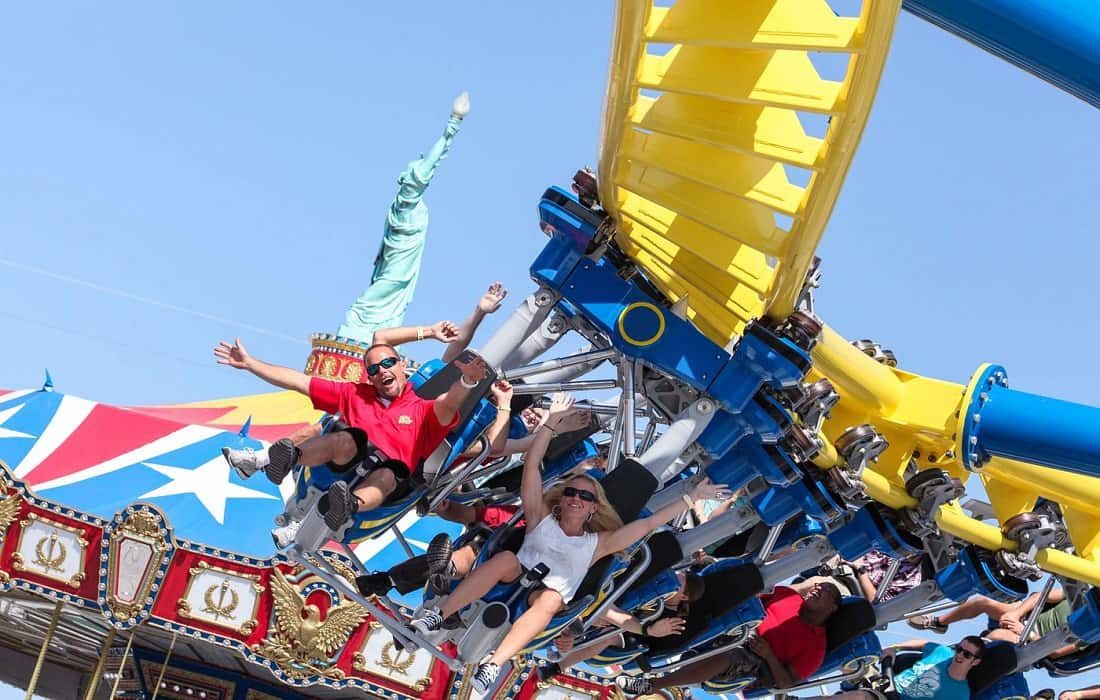 people raising hands and screaming while riding a rollercoaster at Fun Spot Orlando