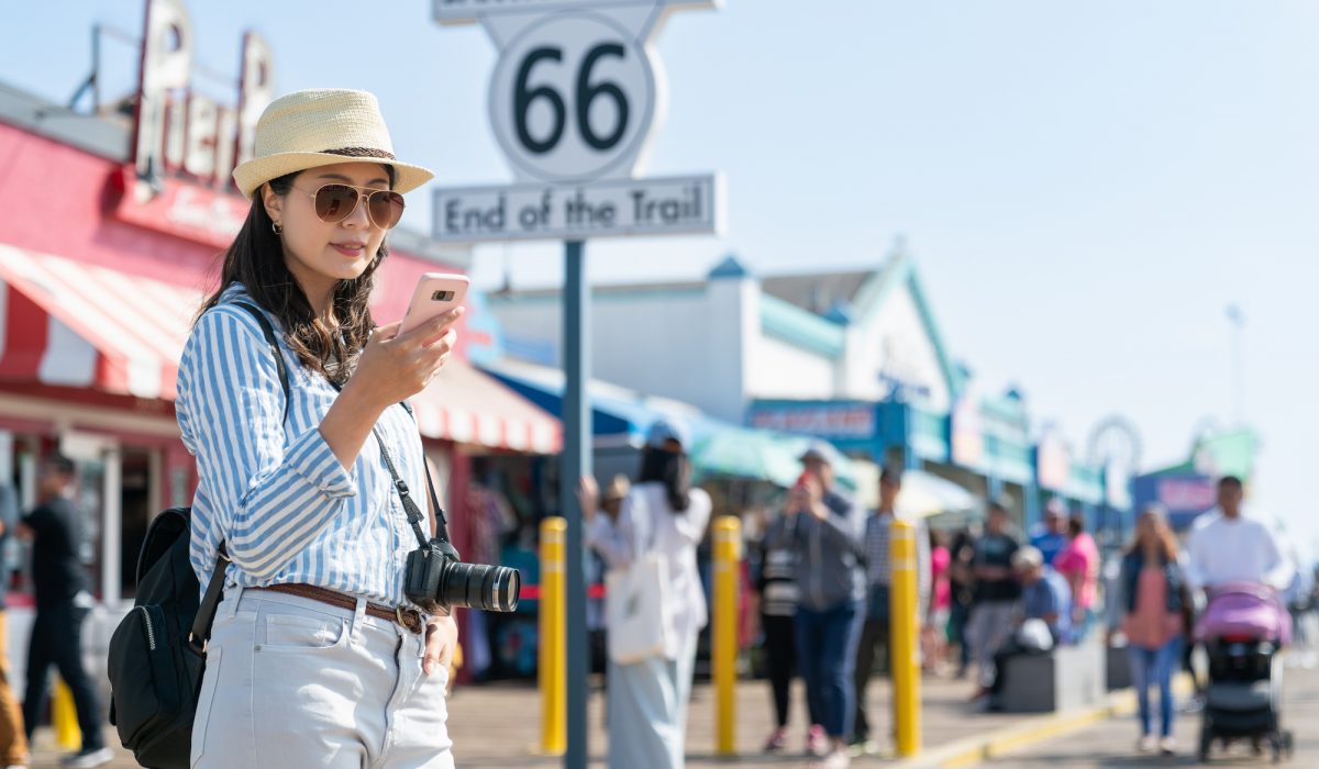 woman using phone at santa monica pier