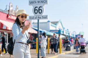 woman using phone at santa monica pier