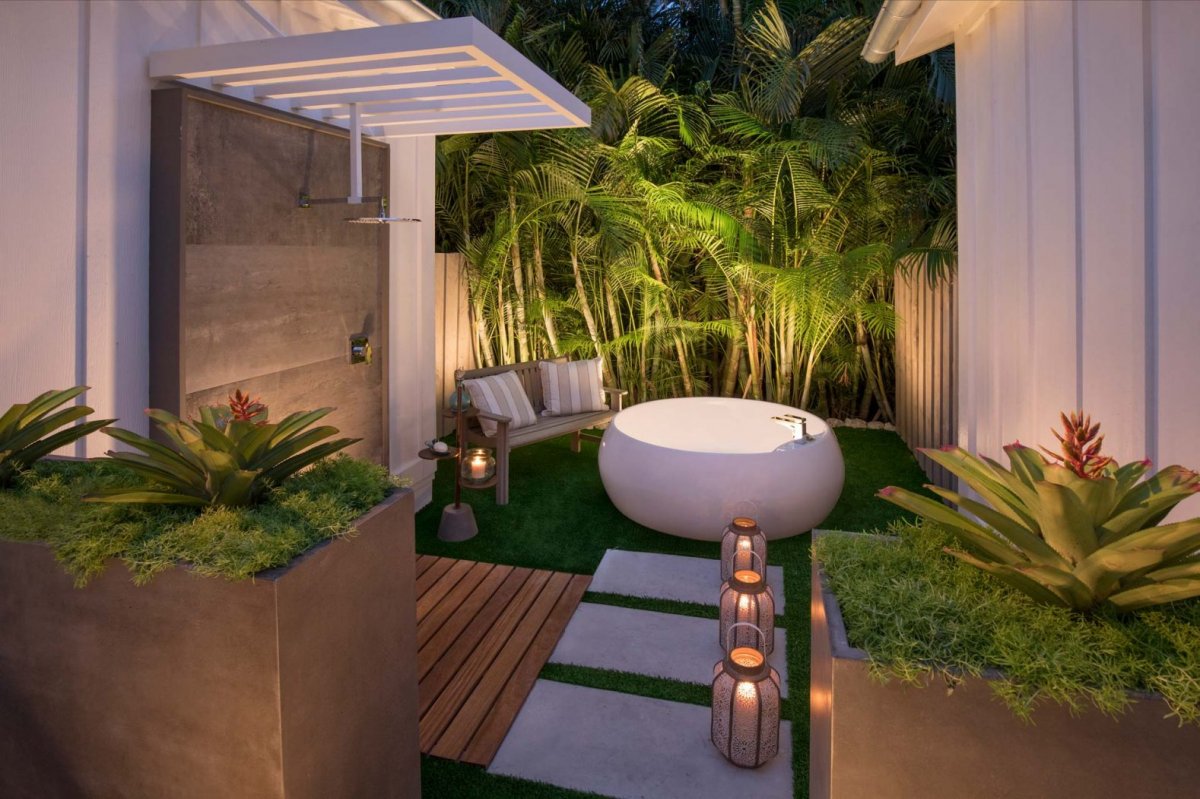 A luxurious outdoor shower and tub in Bungalows Key Largo's Garden Bungalows room in Key Largo, Florida