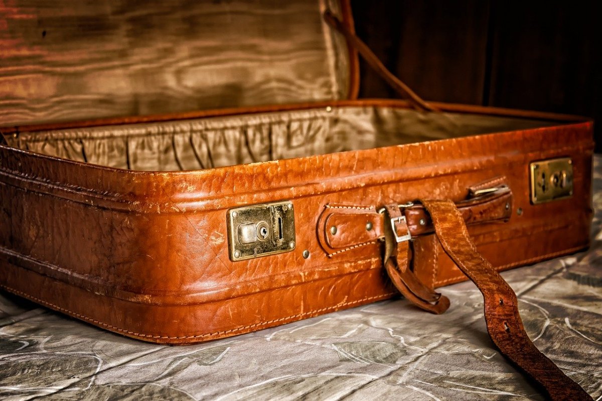 An open luggage sits on a wooden surface