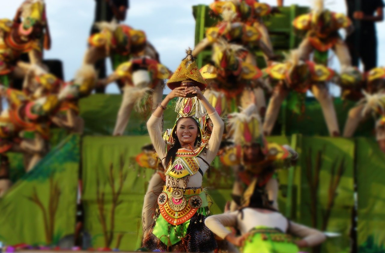Woman holding a statue during the PIntados Kasadyaan Festival parade