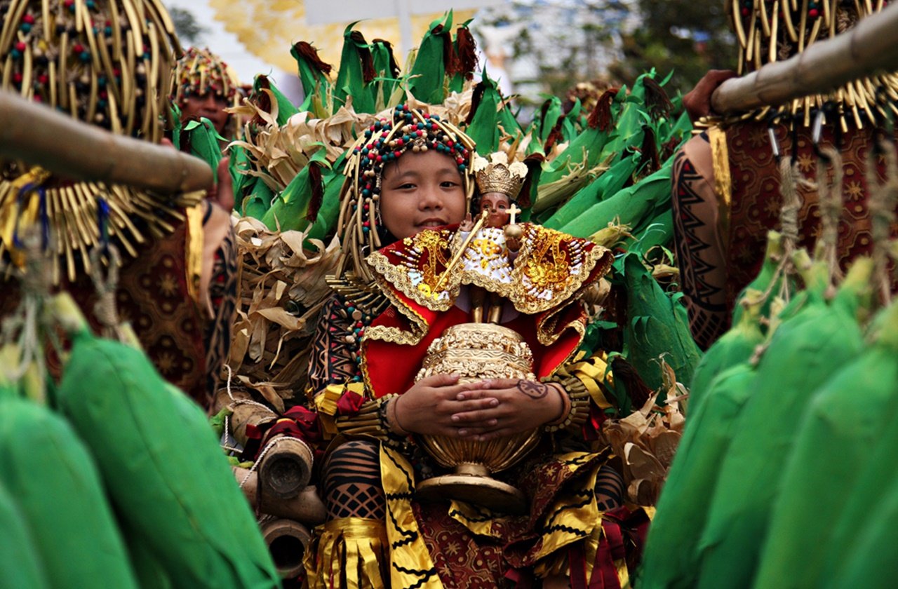 Boy holding a statue of the Sto. Niño in the Sinulog Dance Parade