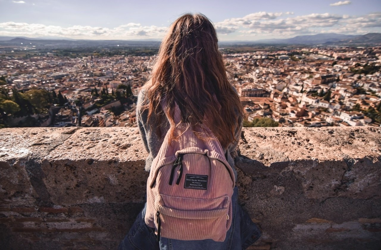Back view of a female tourist looking over Granada