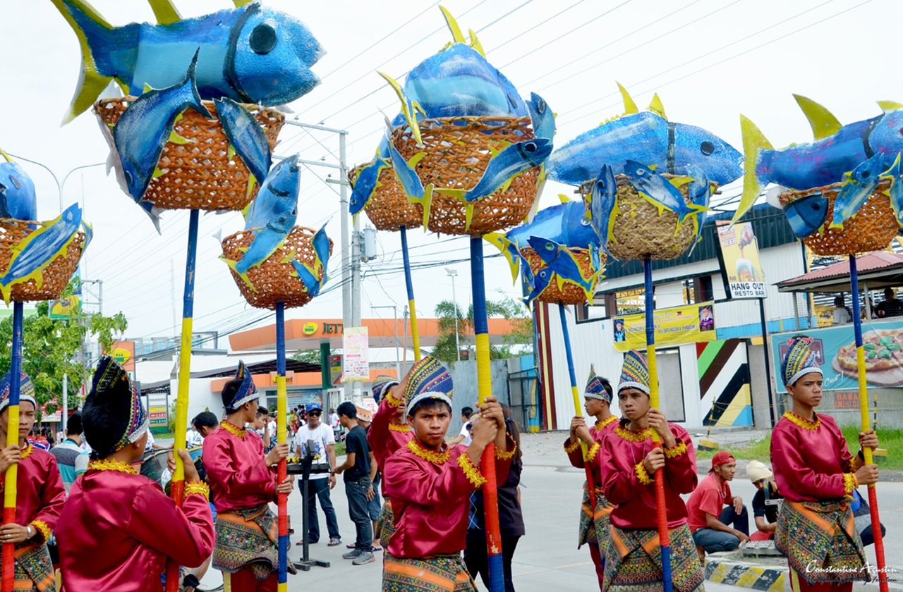 Locals holding ocean-themed props during the Tuna Festival parade