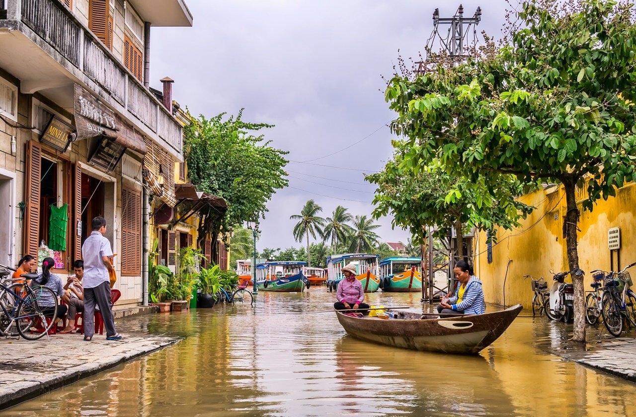 Two women riding a boat in Hoi An