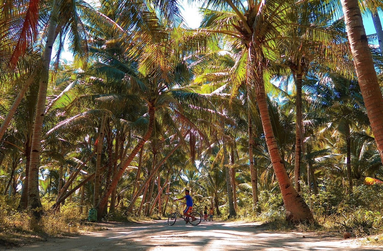 Bantayan island Boy biking in the middle of a street in bantayan island