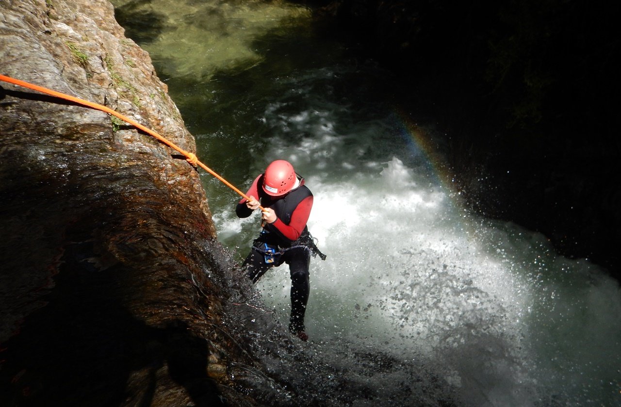 Canyoning Girl abseiling down a canyon