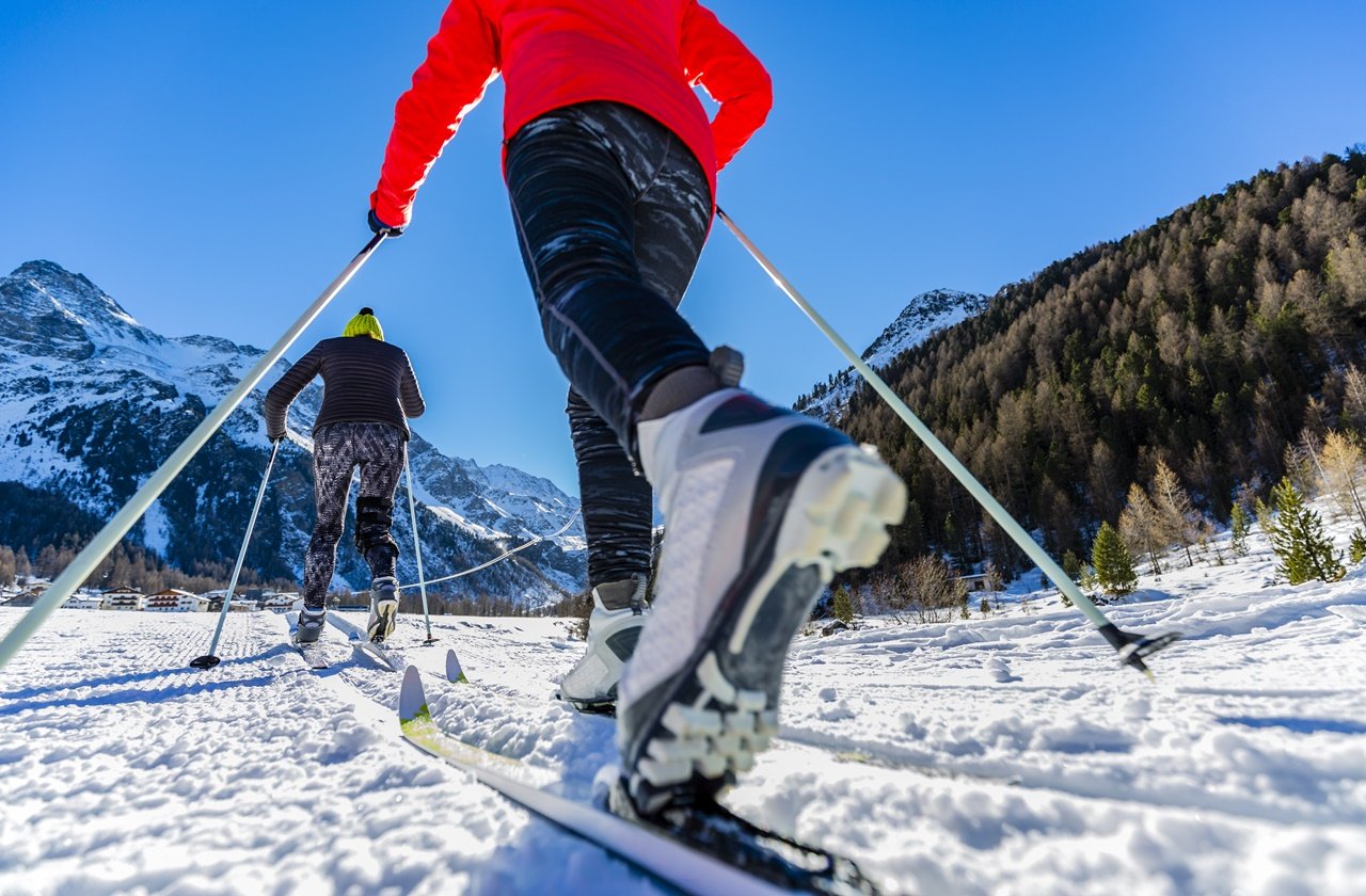 Two skiers cross-country skiing on a mountain
