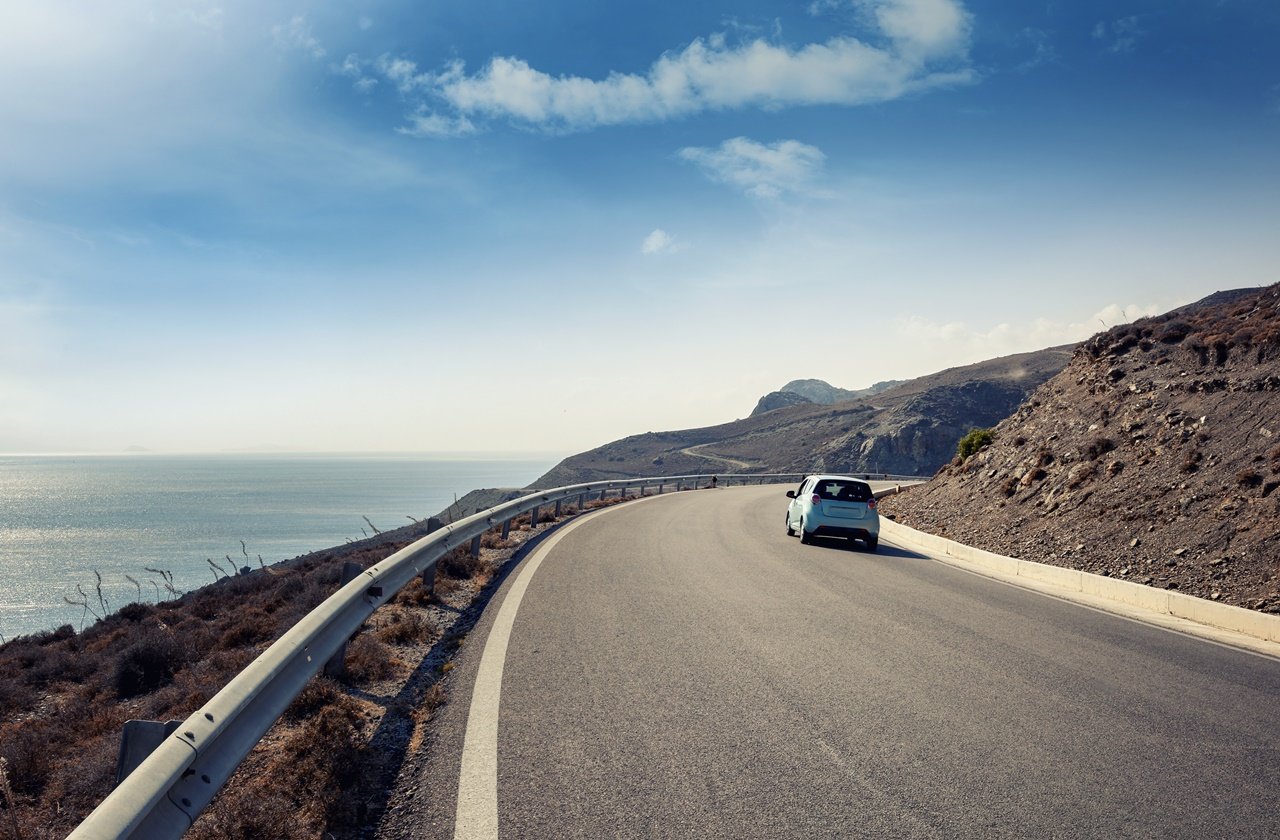 Car driving on a highway next to the sea