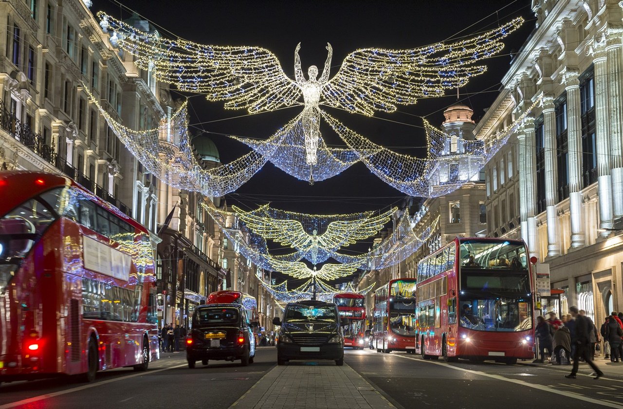 Double decker buses and taxis under the Christmas lights at Regent Street in London