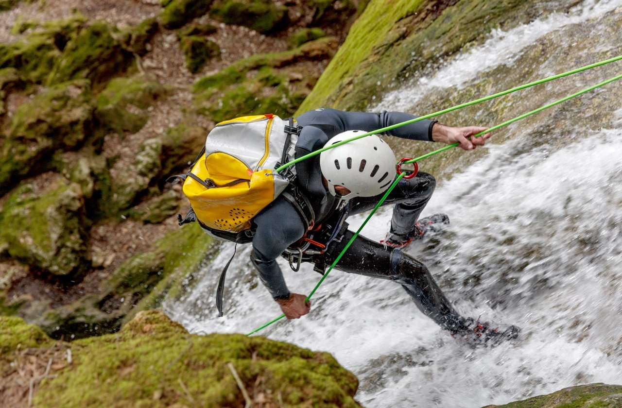 Canyoning Man rappelling down a canyon