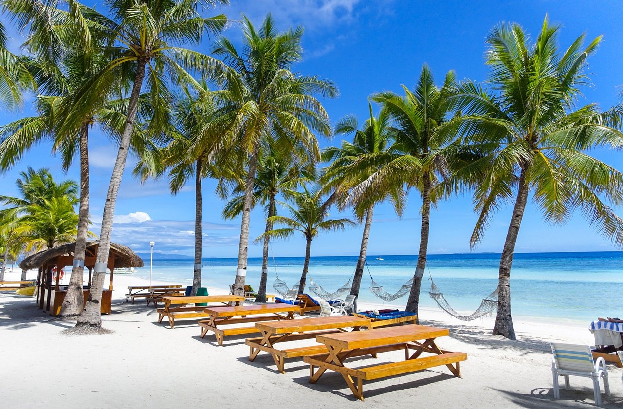 Panglao Island beach Hammocks and picnic tables lined at a resort in Panglao Island