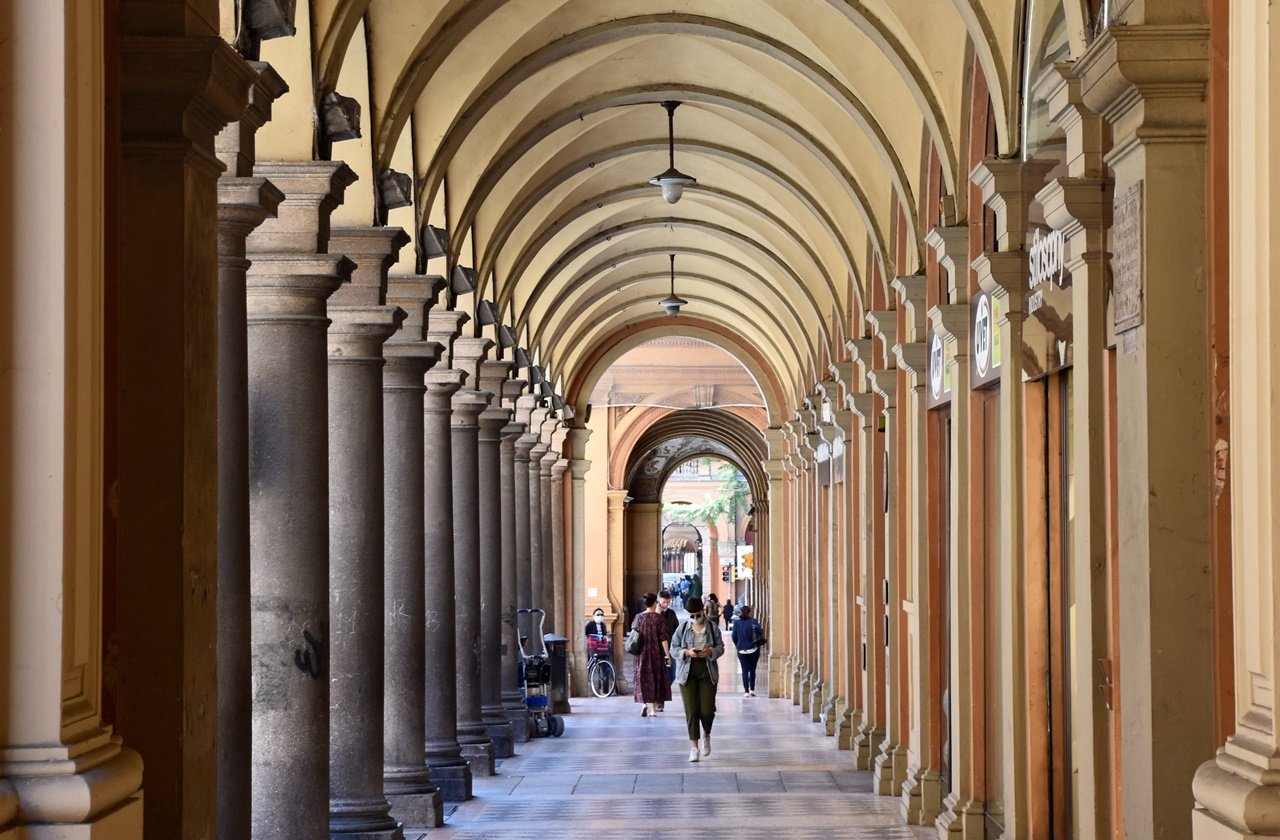 Bologna portico Tourists walking along the porticos in Bologna