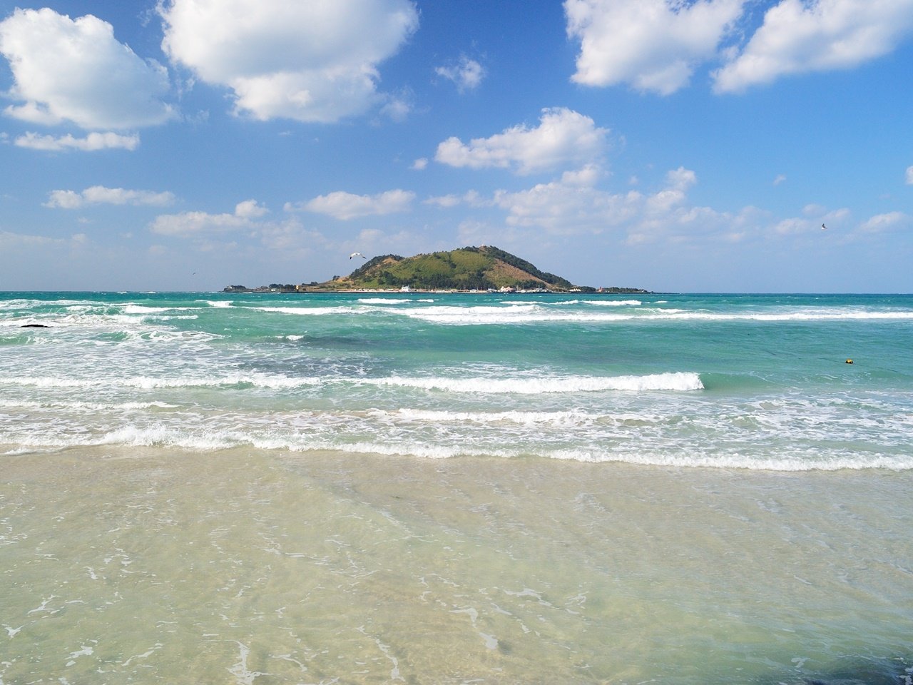 View of Hyeopjae Beach with an island in the distance