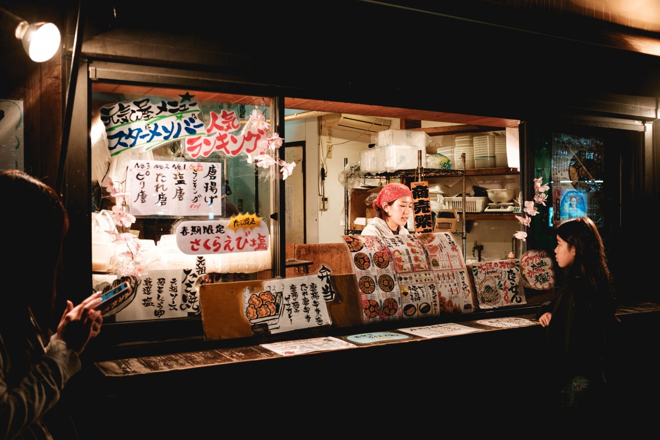 Woman selling food at a stall in Fukuoka