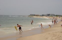Beachgoers running to the shore at Charlestown Town Beach