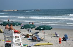 Group of people lounging by the shore of Narragansett Beach