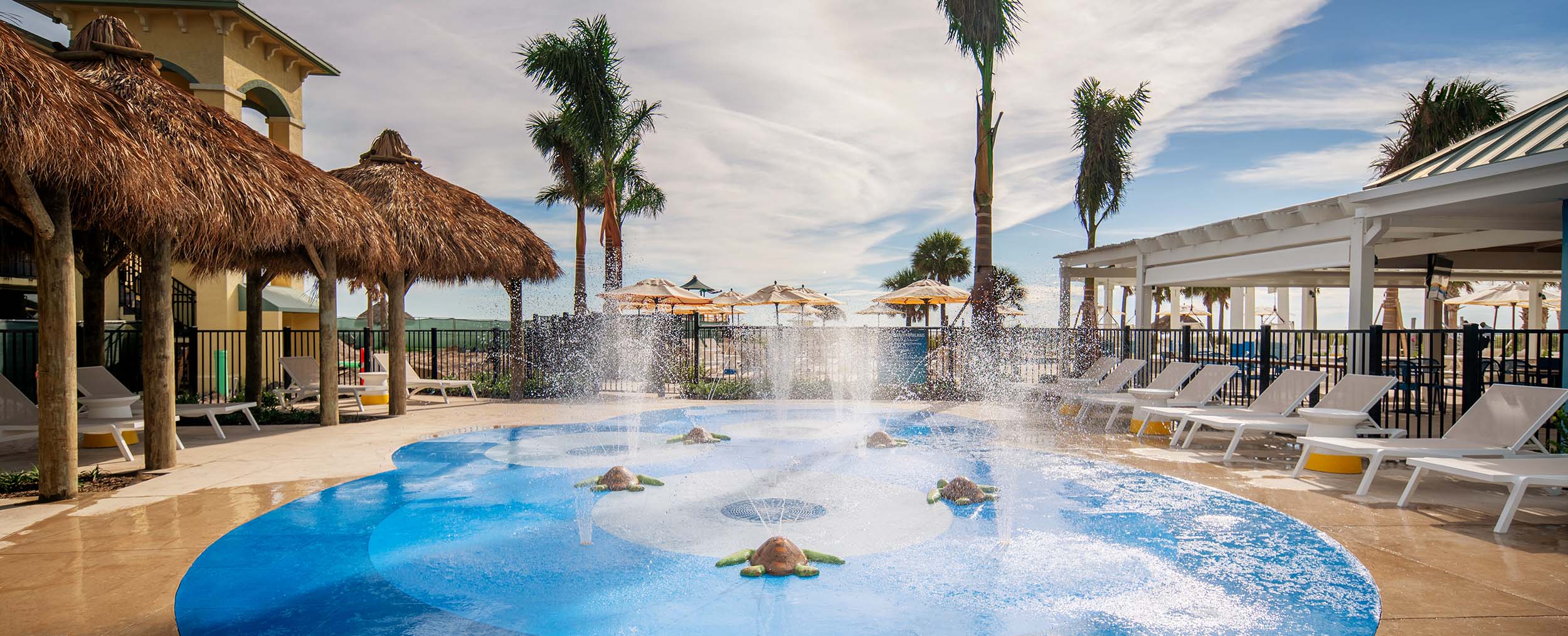Sirata Beach Resort, St. Pete Beach, Florida Lounge chairs sit under palapas surrounding a fountain at Sirata Beach Resort, St. Pete Beach, Florida